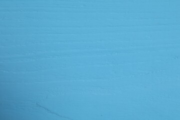 Texture of light blue wooden surface as background, closeup