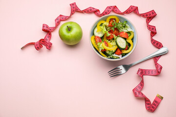 Measuring tape, salad, apple and fork on pink background, flat lay. Space for text