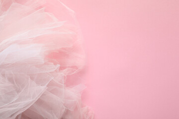 Beautiful tulle fabric on pink background, top view. Space for text