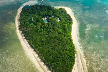 An aerial view of the coral reefs and clear turquoise waters surrounding Green Island, a small...