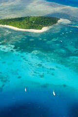 An aerial view of the coral reefs and clear turquoise waters surrounding Green Island, a small tropical isle in the outer Great Barrier Reef — Coral Sea, Cairns; Far North Queensland, Australia	
