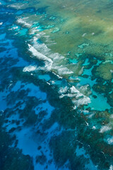 Fototapeta na wymiar An aerial view of the coral reefs, white sand bars, tropical isles and clear turquoise waters of the Great Barrier Reef — Coral Sea, Cairns; Far North Queensland, Australia 