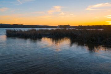 Lake at sunset, and blue-gold colored sky in the background