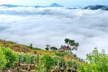 Obraz premium Tourists at Hang Kia-Pa Co. Hang Kia - Pa Co valley is surrounded by four rocky mountains, covered with clouds all year. Hang Kia-Pa Co in Mai Chau district, Son La province, Vietnam
