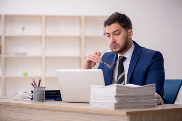 Young male employee working in the office