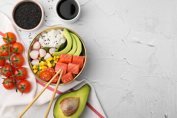 Delicious poke bowl with salmon, avocado and vegetables on white textured table, flat lay. Space...