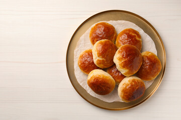 Plate with freshly baked soda water scones on white wooden table, top view. Space for text