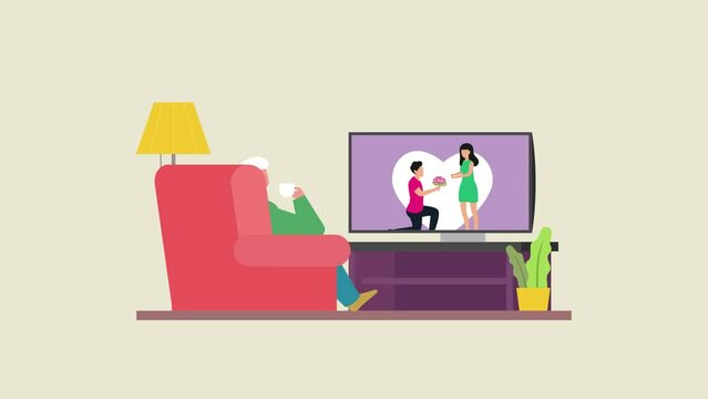 Old man watching TV at home while drinking tea