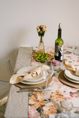Vintage table setting with Linen napkins and floral decorations. Close up. Cozy calm meal in the morning in the sunshine.