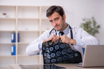 Young male doctor radiologist working in the clinic