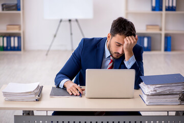 Young male employee working in the office