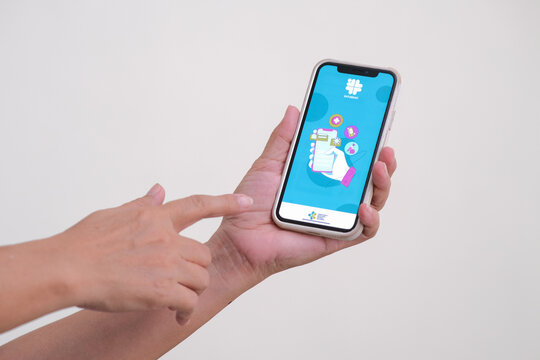 Hands holding smartphone to access "satu sehat" in Yogyakarta, 20 February 2023