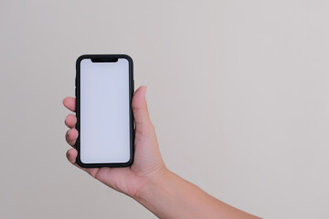Hand holding a smartphone over white flat background