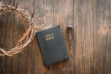 Crown thorns and holy bible or book on a wood background, copy space. Concept for faith,...