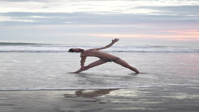 Men practicing yoga beach ocean movement body sunset vertical video asana
