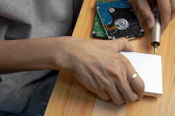 top view, man assembling an external hard drive