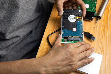 top view, man assembling an external hard drive