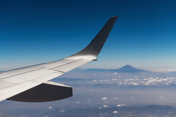 Fototapeta na wymiar Pico de Orizaba or Citlaltepetl volcano, highest mountain peak of Mexico, seen from airplane with wing.