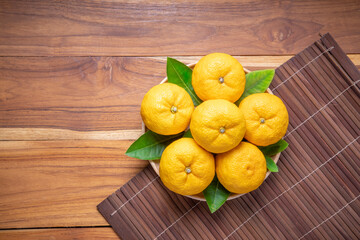 Yuzu Orange fruit on Wooden backghround. Sweet Yuzu Orange fruit in Wooden table.