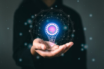 Hand with light bulb and brain icon futuristic future digital technology. Success creativity invention, thinking imagination marketing online. Innovation for modern business intelligence concept.