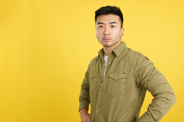 Confident chinese man standing looking at the camera