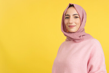 Happy muslim woman wearing hijab looking at the camera