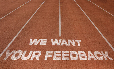 We Want Your Feedback written on running track, New Concept on running track text in white colour