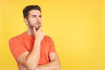 Caucasian man with hand on face and thoughtful expression