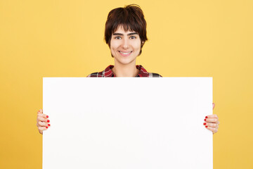 Fototapeta premium Androgynous person holding a blank panel while smiling