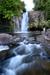 Tourists visit the waterfall in a tropical forest of Binh Lieu District, Quang Ninh Province, Vietnam