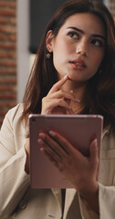 Young beautiful businesswoman working on tablet in office.