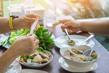 Enjoy eat with Vietnamese Meatball Wraps (Nam-Neung), Pork Sausage wraps with fresh vegetables in rice paper, generous platter eat with sweet sauce. Vietnamese Pork Sausage and salad. Selective focus.