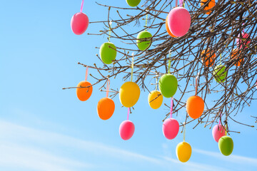 Multi-colored Easter eggs against the background of a light blue sky