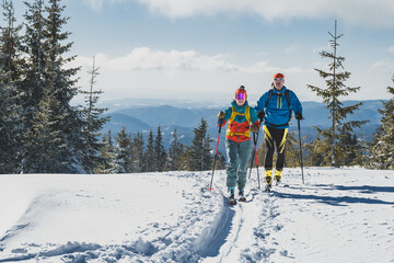 Mountaineer backcountry ski walking ski alpinist in the mountains. Ski touring in alpine landscape with snowy trees. Adventure winter sport. Kralova hola, Slovakia © Zedspider