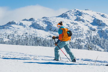 Mountaineer backcountry ski walking ski alpinist in the mountains. Ski touring in alpine landscape with snowy trees. Adventure winter sport. Kralova hola, Slovakia © Zedspider