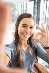 Selfie, portrait and business woman with ok sign for success, agreement and perfect emoji in office. Picture, smile and happy female worker with hand gesture for okay, good job and yes icon at desk