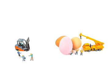 miniature worker people and egg , isolated on white background for Easter holiday concept.