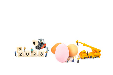 miniature worker people and egg , isolated on white background for Easter holiday concept.