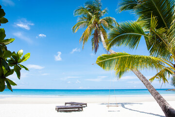 beach landscape background for summer travel with sun, coconut tree on white sand beach with beautiful blue sea and sky