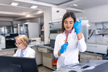 Modern Medical Research Laboratory: Female Scientist Working with Micro Pipette, Using Digital Tablet for Test Sample Analysis. Advanced Scientific Lab for Medicine, Biotechnology Development. - obrazy, fototapety, plakaty
