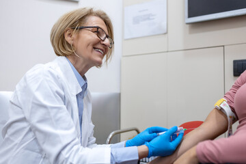 Preparation for blood test with pretty young woman by female doctor medical uniform on the table in...