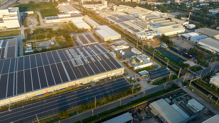 Top view Solar Panels on Warehouse Factory. Solar photo voltaic panels system power or Solar Cell on industrial building roof for producing green ecological electricity. Production of renewable energy