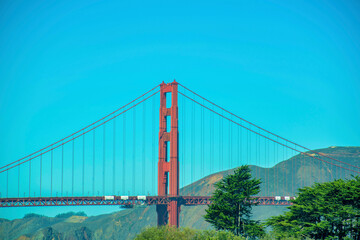 Golden gate bridge in suburban distance with natural hills and ocean mountain background in san francisco california