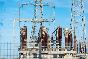 High voltage circuit breaker in a power substation.Electric power transmission lines in the...