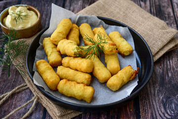  Traditional fried  Potato Croquettes with Cheese  dipping sauce on wooden board