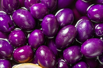 Olive with blueberries flavor. Close-up pile of purple kalamata olives