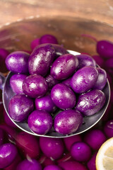 Olive with blueberries flavor. Close-up of purple kalamata olives in spoon