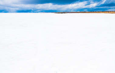 Tranquil view of snow covered field against sky