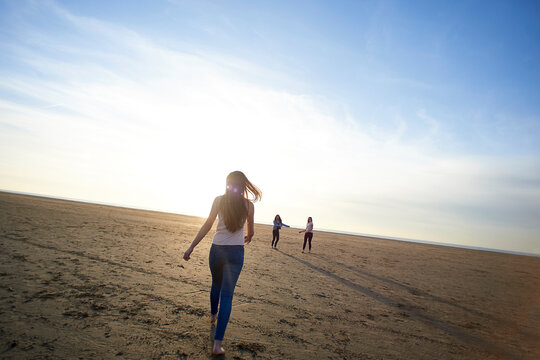 Female friends walking on land against sky