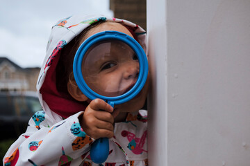 Portrait of girl holding magnifying glass